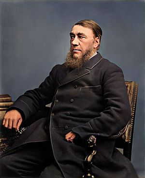 Paul Kruger as an old man with a grey beard wearing a black top hat as well as pirate style earrings