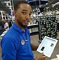 Salesperson at Best Buy demonstrating Apple IPad