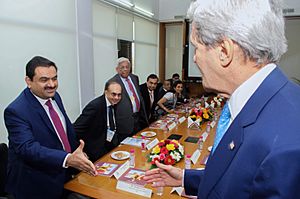 Secretary Kerry greets Executive Chairman Adani before meeting with Indian CEOs amid Vibrant Gujarat Summit