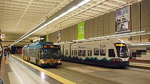 Metro bus and Link light rail passing at University Street Station (2010)