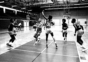 Journalist George Plimpton playing basketball with some students at the Miami-Dade Community College North Campus