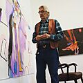 Rick Bartow with his paintings at Froelick Gallery, Portland, Oregon