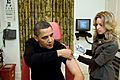 A nurse vaccinates Barack Obama against H1N1