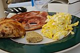 Ham and eggs served with scrambled eggs
