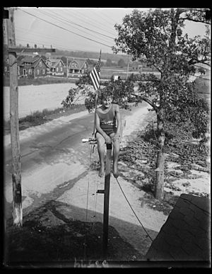 Maryland youth breaks pole sitting record. William Ruppert, 14-year-old youth of Colgate, Maryland, as he appeared atop the flag pole in the yard of his home yesterday after breaking the LCCN2016889434