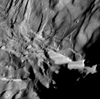 Close-up view of Verona Rupes, a 20 km high fault scarp on Miranda, a moon of Uranus.