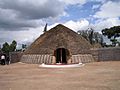 Photograph of King's palace in Nyanza, Rwanda depicting main entrance, front and conical roof