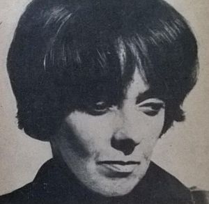 Black and white portrait of a short-haired woman glancing down and to the left.