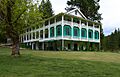 The Wawona Hotel, a broad, two-story hotel building with trees in the background.