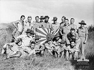 NGVR soldiers with captured Japanese flag 28 Aug 1942 (AWM 013147)