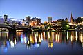 Princes Bridge, Flinder Street Station, Federation Square and St. Paul's Cathedral and Melbourne CBD on the background from the Yarra river