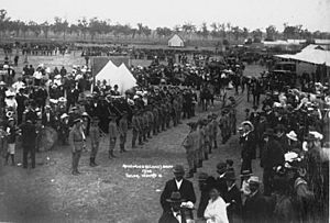 StateLibQld 2 122816 Crowds at the Rosewood show watching cadets formed into a guard of honour for a visiting dignitary, 1908