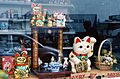 Collection of gold and white Maneki Neko in store window