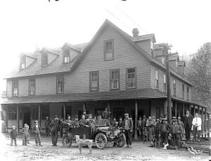 Group of people posed with automobile in front of the Index Hotel, Index, October 12, 1911 (PICKETT 3)