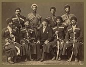 Group portrait of eight Circassian men in uniform, with another man, possibly an Ottoman official