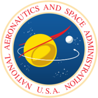 A blue sphere with stars, a yellow planet with a white moon; a red chevron representing wings, and an orbiting spacecraft; surrounded by a white border with "NATIONAL AERONAUTICS AND SPACE ADMINISTRATION U.S.A." in red letters