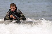 US Navy 090624-N-7883G-011 A Basic Underwater Demolition-SEAL (BUD-S) student wades ashore on San Clemente Island during an over the beach exercise