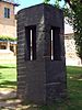 Granite sculpture consisting of a rough-hewn rectangular pillar enclosing a more polished rectangular internal structure