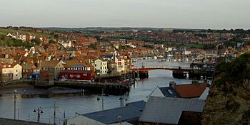 The harbour and marina at Whitby, with the swing bridge in the middle ground and buildings surrounding the water