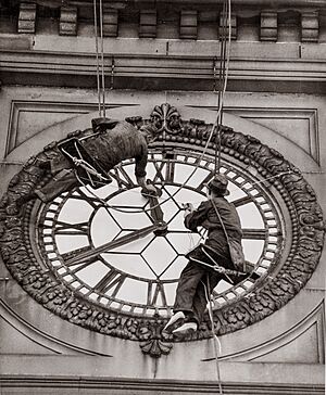 Cleaning the clock face of Sydney Town Hall, George Street Sydney, 1937
