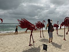 Flamingo sculptures on the beach