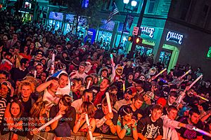 photo of large crowd in multiple costumes gathered in front of a stage during halloween 2015 in athens ohio