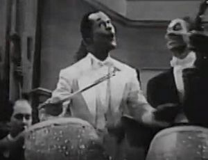 Cee Pee Johnson (with unidentified musicians), performing his composition, "Beat My Blues Away," in Mystery in Swing (1940).jpg