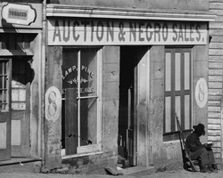 United States Colored Troop enlisted African-American soldier reading at 8 Whitehall Street, Atlanta slave auction house, Fall 1864- 'Auction & Negro Sales,' Whitehall Street LOC cwpb.03351 (cropped)