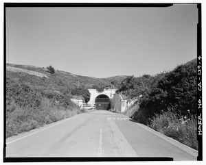 DISTANT VIEW OF THE WEST PORTAL, LOOKING EAST. - Forts Baker-Barry Tunnel, Under Lime Point Ridge on Bunker Road, Sausalito, Marin County, CA HAER CAL,21-SAUS.V,3-4