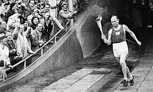 Paavo Nurmi enters the Olympic Stadium in 1952