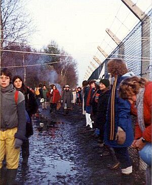 Embracing the base, Greenham Common December 1982 - geograph.org.uk - 759090