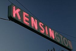 A neon sign hangs over Adams Avenue, the main thoroughfare in Kensington.