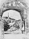 An engraving of an arch through which is a church with a broach spire. Gates frame the arch and on the right stands a girl in Victorian dress