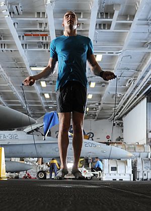US Navy 101004-N-6427M-149 Airman David Hall, from Buffalo, N.Y., jumps rope during a training session in the hangar bay aboard the aircraft carrie