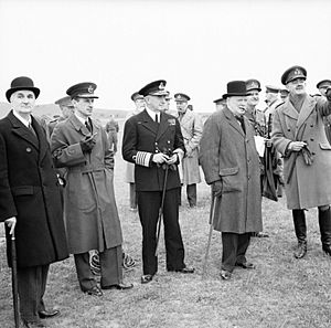 Winston Churchill with his scientific advisor Lord Cherwell (extreme left), Air Chief Marshal Sir Charles Portal and Admiral of the Fleet Sir Dudley Pound, watching a display of anti-aircraft gunnery, June 1941 H10306