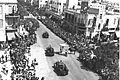 BRITISH ARMOURED VEHICLES PARADING THROUGH ALLENBY STREET IN TEL AVIV, IN HONOR OF THE SILVER JUBILEE OF KING GEORGE V. חיילים בריטיים ברכבים משורייניD22-018