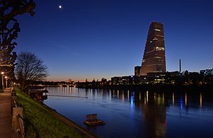 Basel - Roche-Turm mit Stadtansicht bei Abenddämmerung