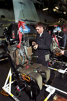 US Navy 040616-N-6213R-001 Aviation Structural Mechanic 3rd Class Robert Hall, of Whidbey Island, Wash., works on a rocket propelled ejection seat, removed from the cockpit of an EA-6B Prowler