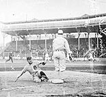 Owen Bush sliding into third base, 1909