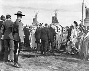 Their Majesties greet chieftains of the Stoney Indian Tribe, who have brought a photo of Queen Victoria