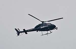 BBC News helicopter watching over the cuts protest