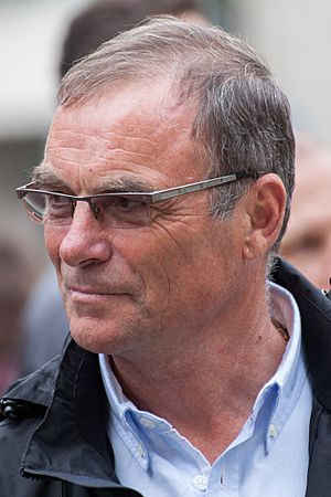 Color photograph of Hinault, looking to the left, wearing glasses