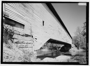 OBLIQUE VIEW FROM SOUTHEAST LOOKING NORTHEAST. NOTE CORNERSTONE IN ABUTMENT. - Jackson Covered Bridge, Spanning Sugar Creek, CR 775N (Changed from Spanning Sugar Creek), HAER IND,61-BLOMD.V,1-5