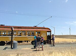 Passengers stand outside of a train from the Western Railway Museum