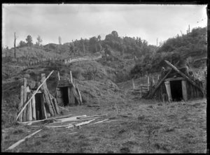 Three food storage pits for storing kumara, at Ruatahuna, 1930. ATLIB 298988