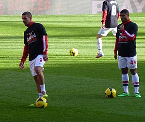 Lukas Podolski x Serge Gnabry warm up v Sunderland - 22 Feb 2014 (cropped)