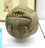 Another aged ball, slightly lighter in colour and more worn. Near the top are five vertical stitches