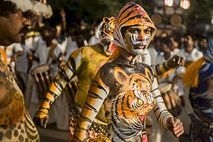 2016 Pulikali Tiger mask dance procession, a woman artist at the Hindu Onam festival Kerala.jpg