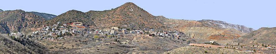 Panorama of Jerome's houses, commercial buildings, and mine sites spread along the flanks of a mountain marked with a large J
