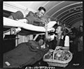SC 196559 - PFC Hiroshi Suyao,of Honolulu, a Japanese American soldier, wounded during an attack, receives cigarettes from Madeleine Carroll, the actress